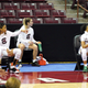 South Carolina guard Zia Cooke (r.) Olivia Thompson, and LeLe Grissett, remain seated during the conclusion of the national anthem, as coaches Dawn Staley and Fred Chmiel, (l.), stand on the sideline before their game.